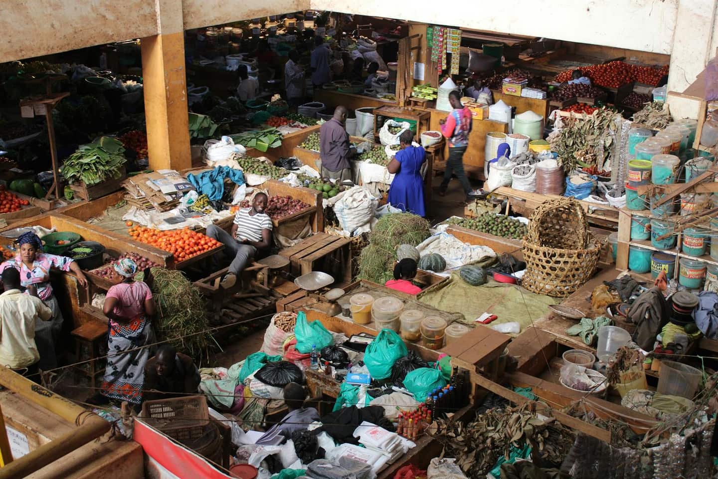 Busy produce market showing trade, food movement, and livelihood activity.