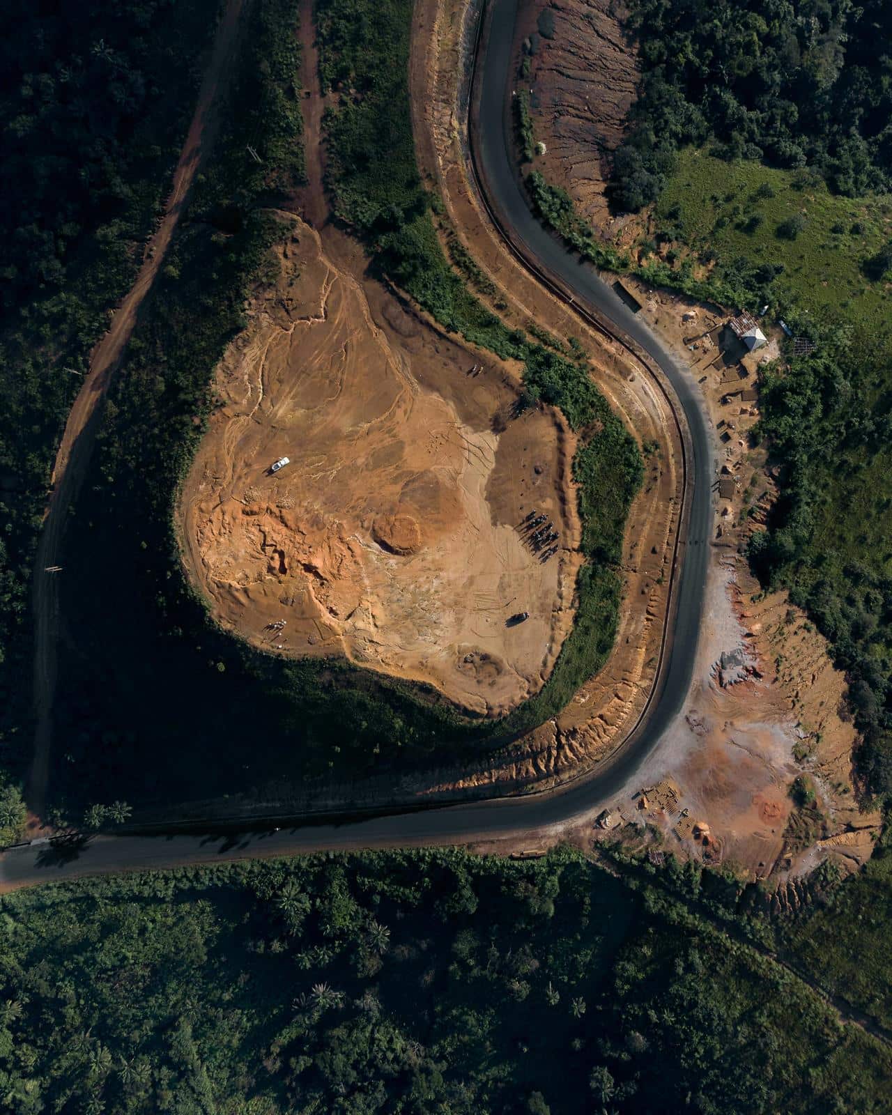 Aerial view of altered land and road infrastructure used to illustrate continental risk and land-use pressure.