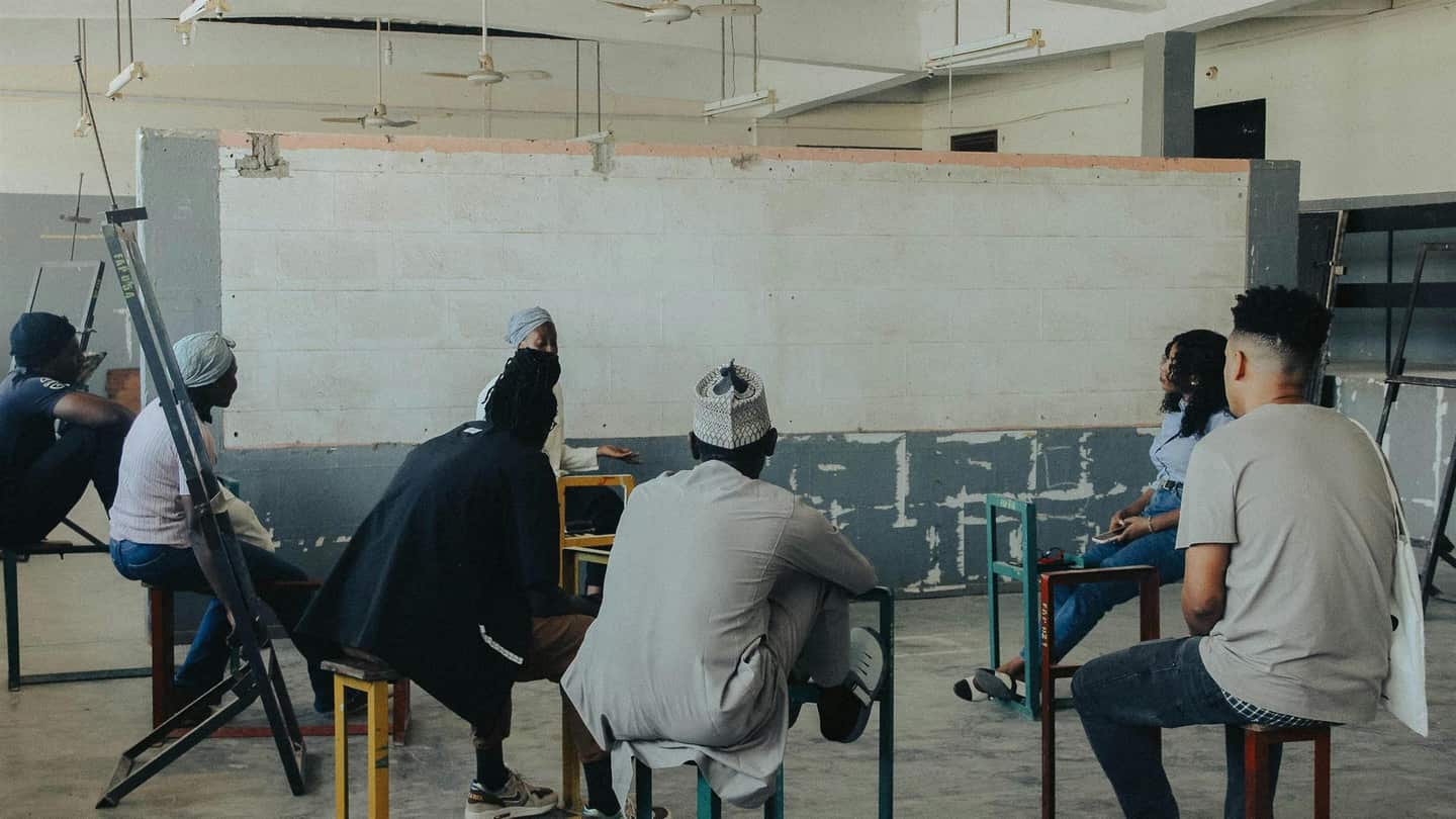 People gathered in a community discussion setting for learning and public awareness.