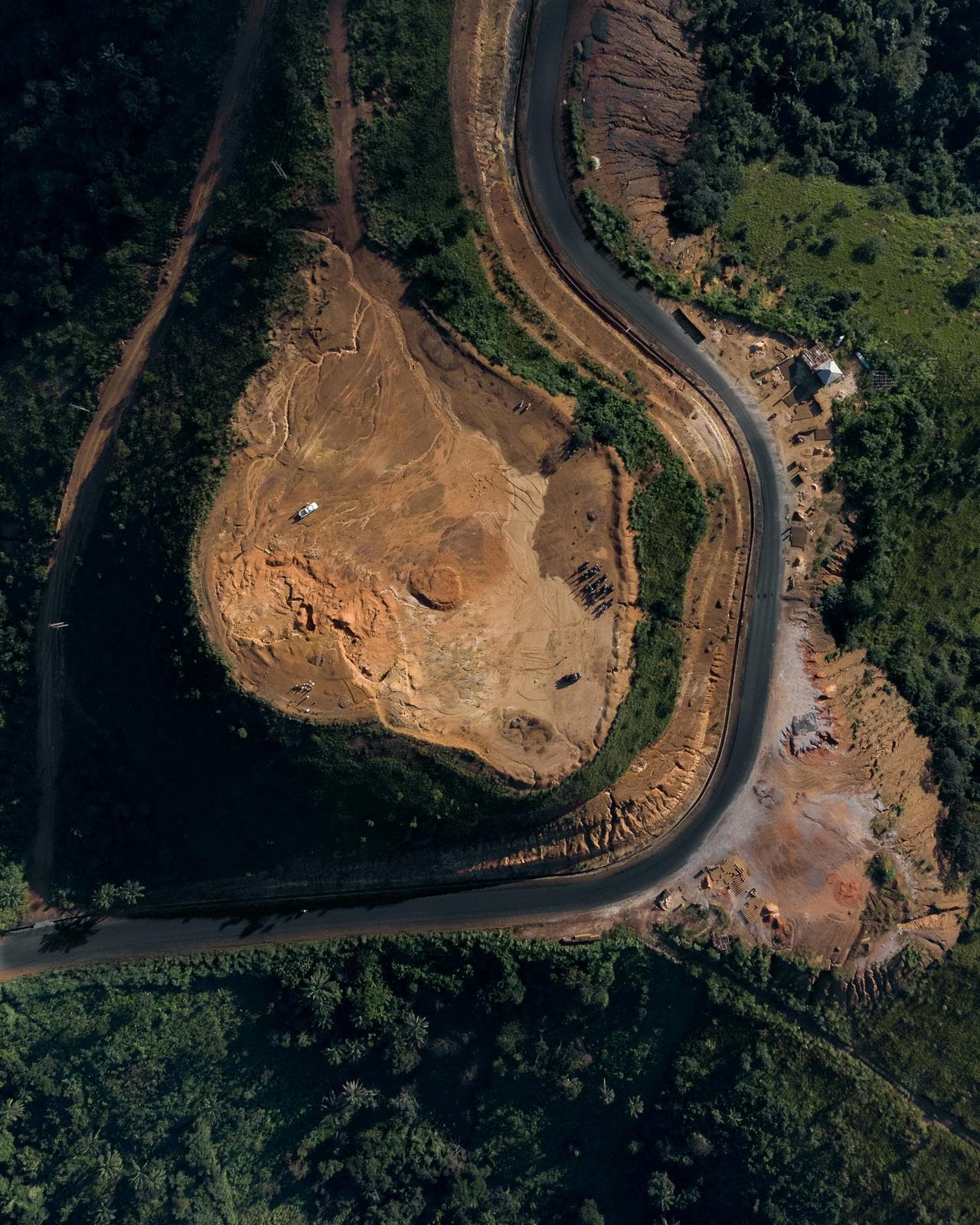 Aerial view of altered land and road infrastructure used to illustrate continental risk and land-use pressure.